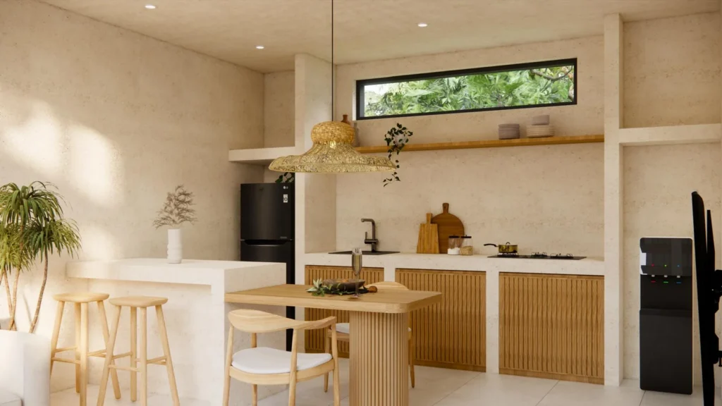 Open-plan kitchen and dining area with island counter inside a one-bedroom villa in Kuta, South Lombok